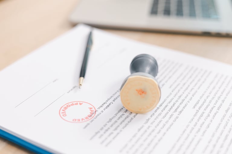 Close up approved stamp on signed document with pen on desk, concept of successful business contract, legal authorization, agreement approval or financial verification process